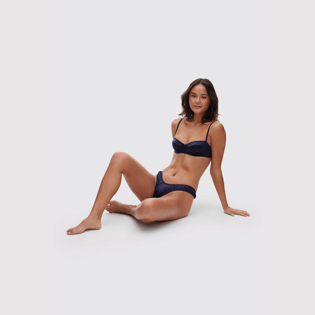 Navy satin balconette bra on model