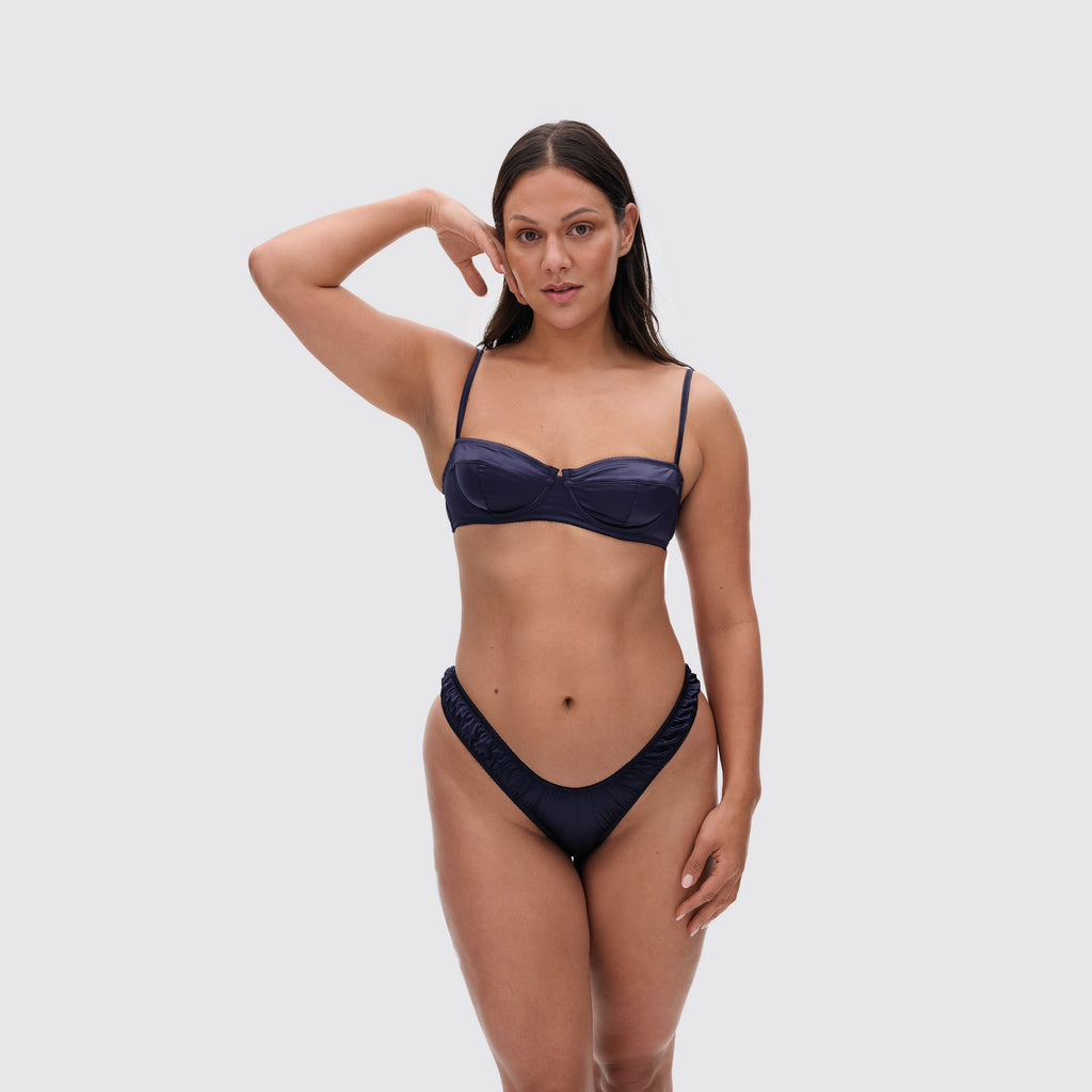 Navy V-shaped satin thong on model, front view