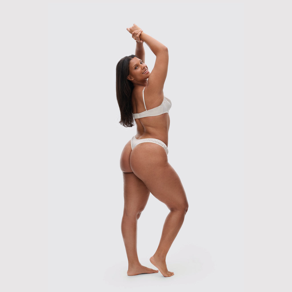 Ivory V-shaped Satin Thong on model, side view 